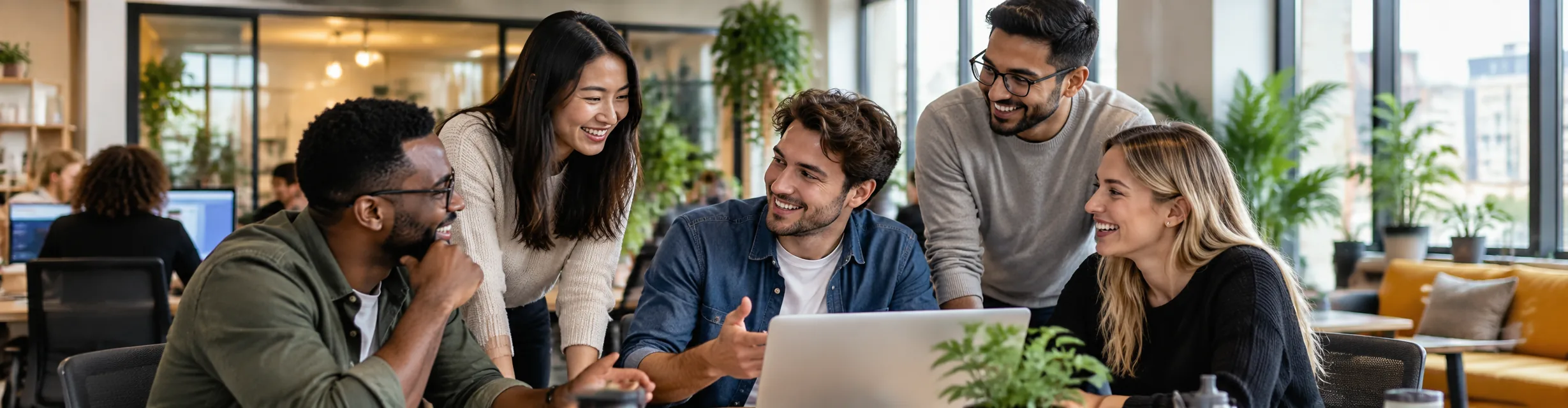 People connecting over a laptop in a bright shared space